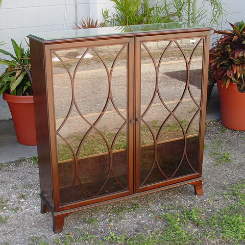 Appraisal: DOUBLE DOOR GLASS FRONT MAHOGANY BOOKCASE Wood lattice over the