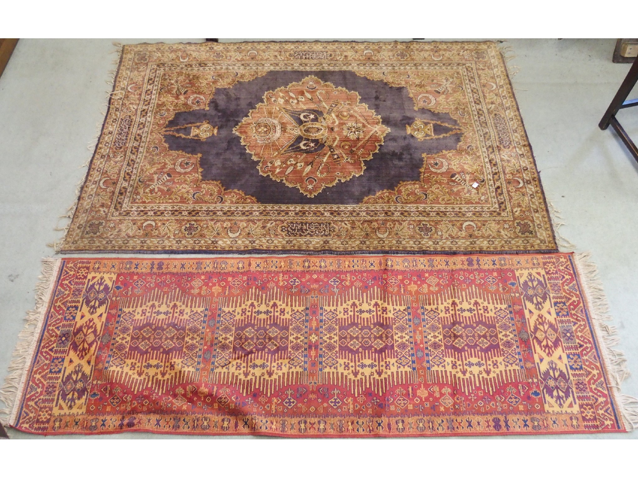 Appraisal: A red ground runner x cm and a rust rug