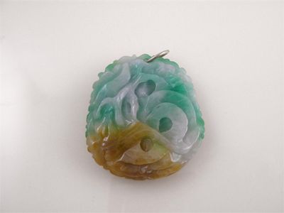 Appraisal: A jade pendant the foliate carved jadeite plaque with a