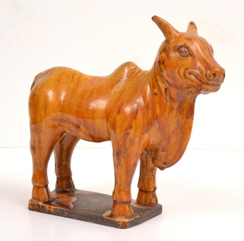 Appraisal: A CHINESE CHESTNUT GLAZED EARTHENWARE OXEN IN THE TANG DYNASTY