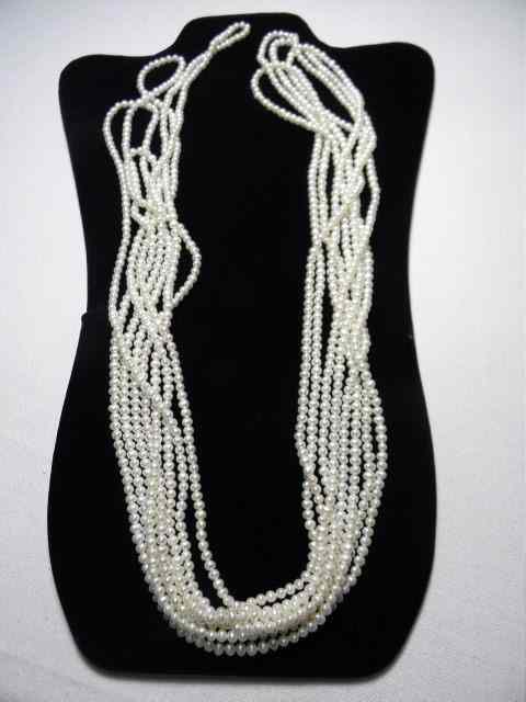 Appraisal: An extra long single strand of small pearls Strand measures