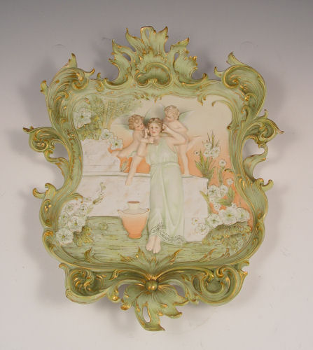 Appraisal: VOLKSTEDT GERMAN BISQUE PLAQUE Woman and cherubs ornate acanthus leaf