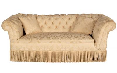 Appraisal: A button back Chesterfield sofa upholstered in cream damask with