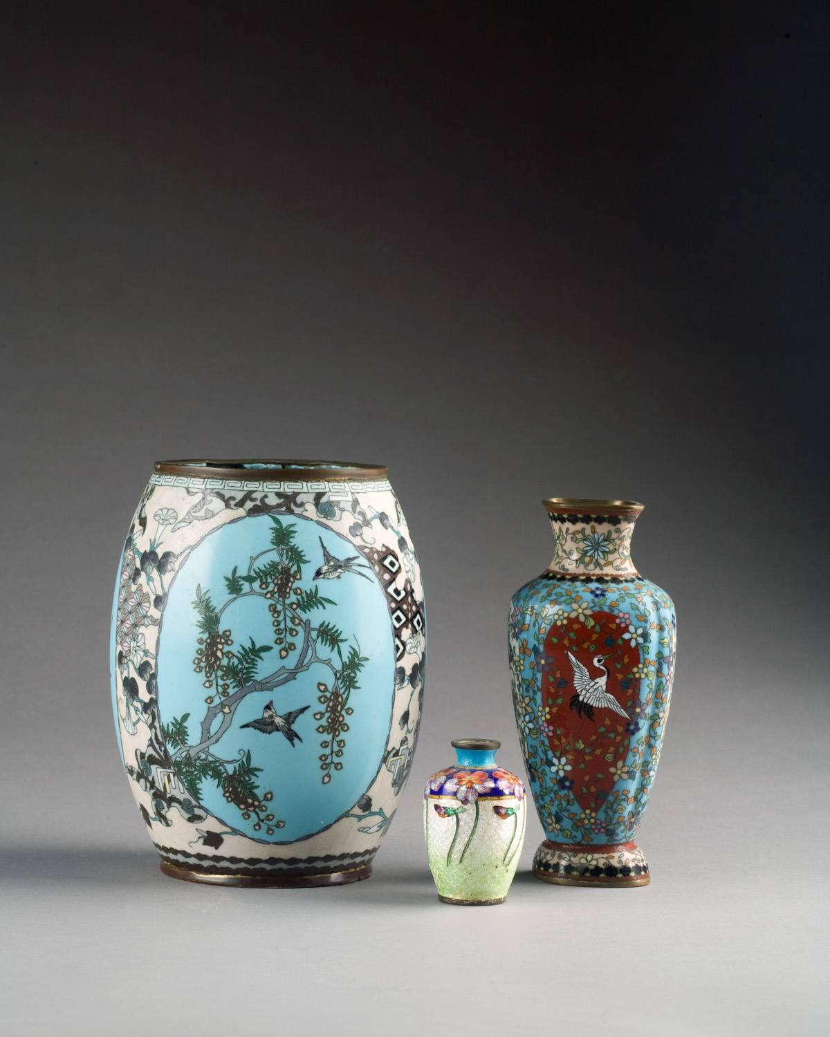 Appraisal: THREE ORIENTAL CLOISONNE VASES The first of barrel form divided