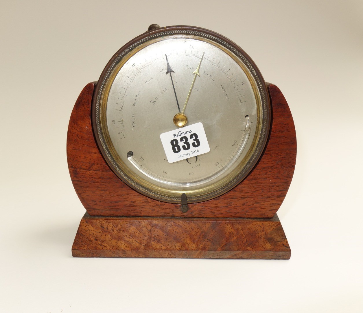 Appraisal: A brass cased table aneroid barometer presentation engraved to the