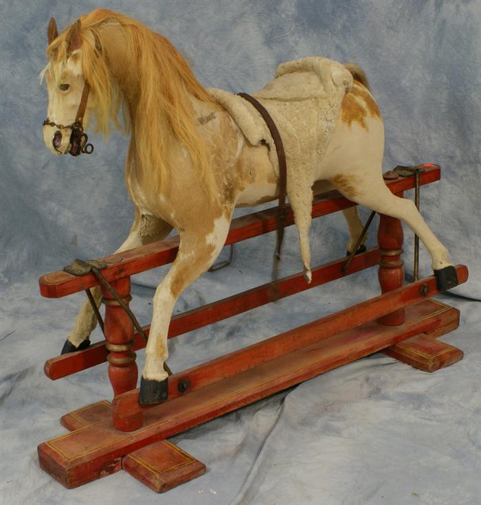 Appraisal: Tan and white felt covered gliding horse English c l