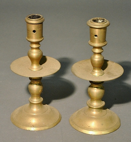 Appraisal: - Two similar near pair of early brass candlesticks with