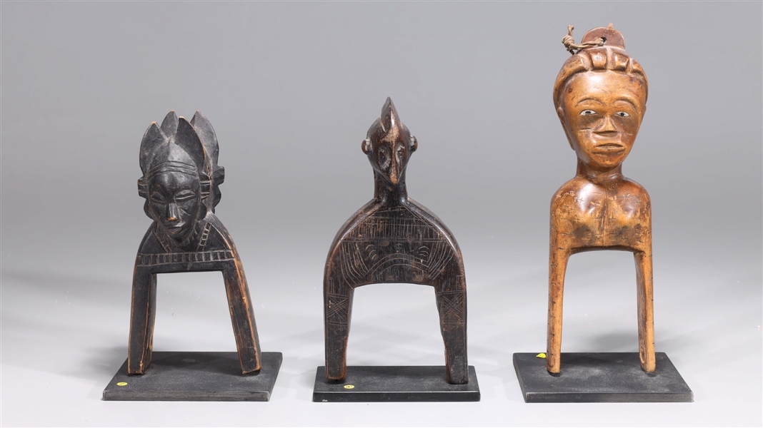 Appraisal: Group of three African pulley each with custom stand overall