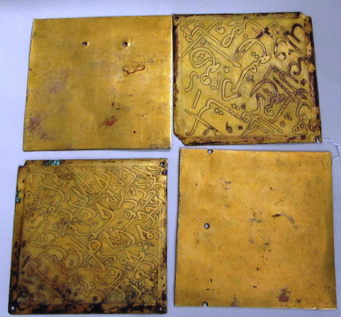 Appraisal: Four Qajar gilt-copper panels Iran dated AH - A D