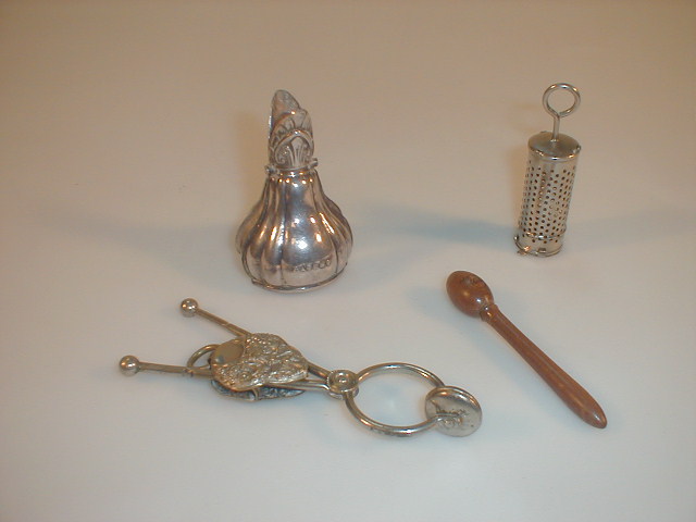 Appraisal: A silver plated ham bone holder a chrome tea infuser