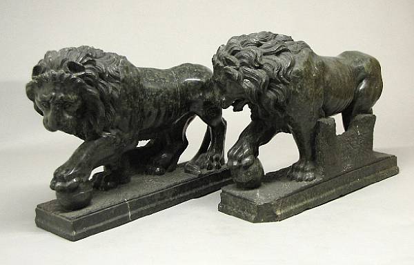 Appraisal: A pair of green serpentine models of standing lions after