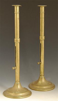 Appraisal: A pair of tall brass candlesticks the knopped stem with