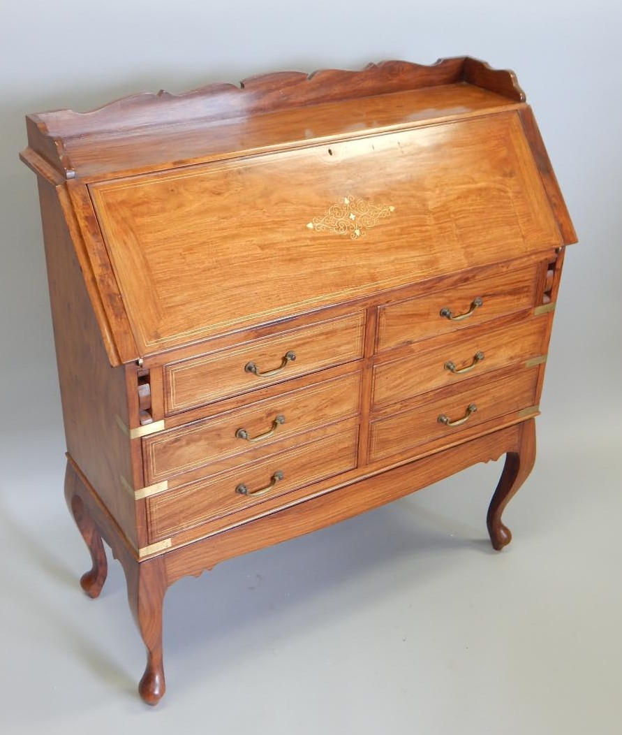 Appraisal: An Eastern hardwood and brass inlaid bureau the top with