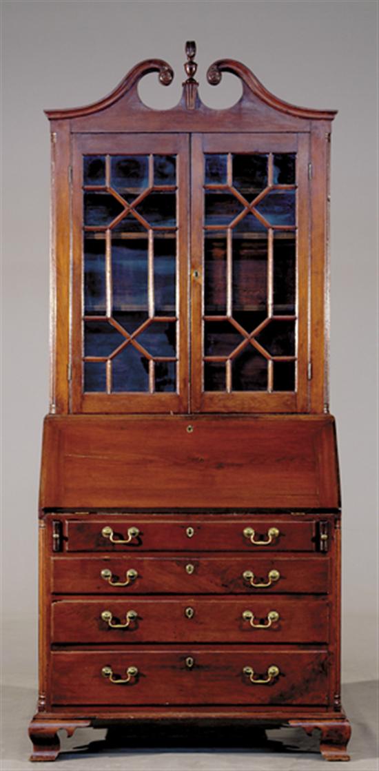 Appraisal: Southern walnut secretary bookcase circa scrolled swan-neck pediment centering flame