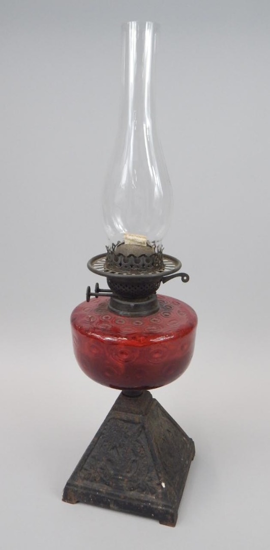 Appraisal: A Victorian oil lamp with a ruby tinted reservoir and