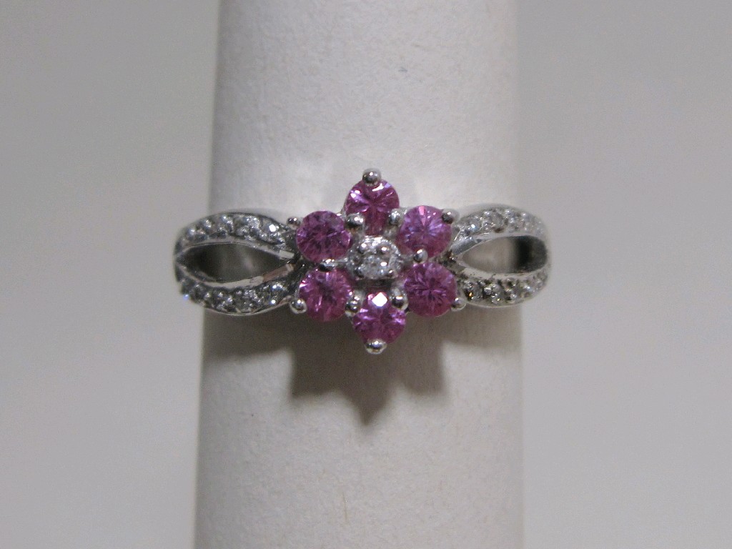 Appraisal: Nine carat white gold pink sapphire and diamond cluster ring