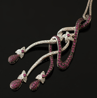 Appraisal: A ruby and diamond pendant necklace The large stylised floral