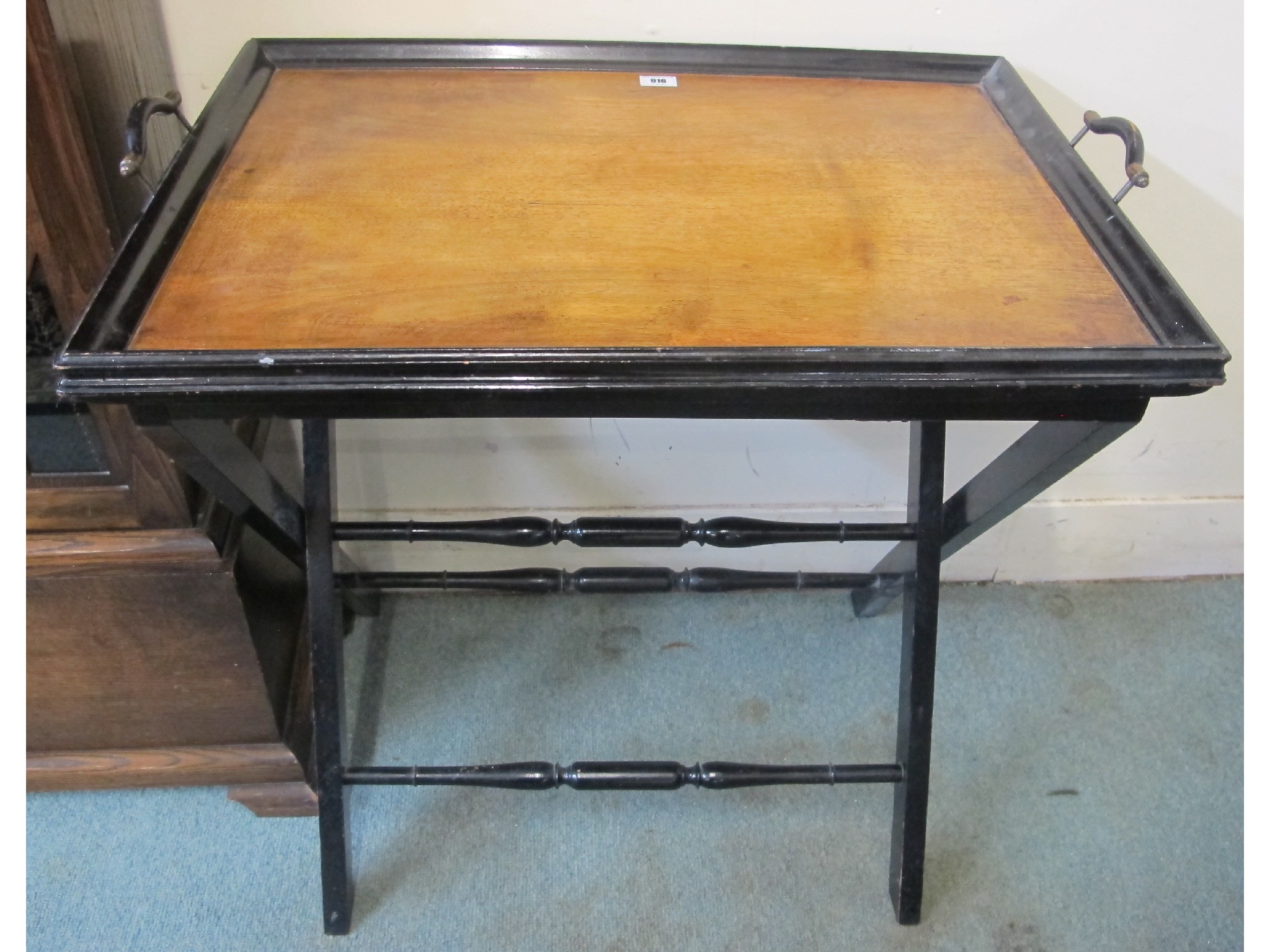 Appraisal: An ebonised serving tray on stand