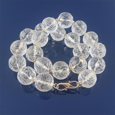 Appraisal: A carved rock crystal bead necklace each bead seperated with