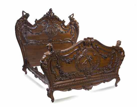 Appraisal: A Baroque Revival Carved Walnut Bed the headboard and footboard