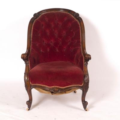 Appraisal: A Victorian mahogany armchair with button back the frame acanthus