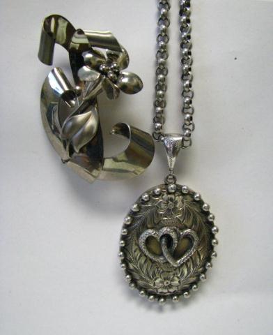 Appraisal: Vintage sterling locket and floral pin hand-chased locket with joined