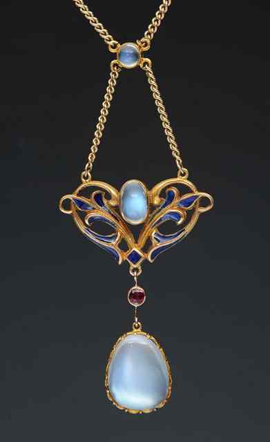 Appraisal: AN ART NOUVEAU STYLE MOON RUBY AND ENAMEL PENDANT AND