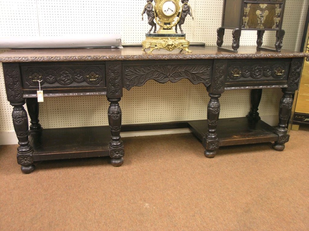 Appraisal: A late Victorian dark carved oak sideboard two carved drawers