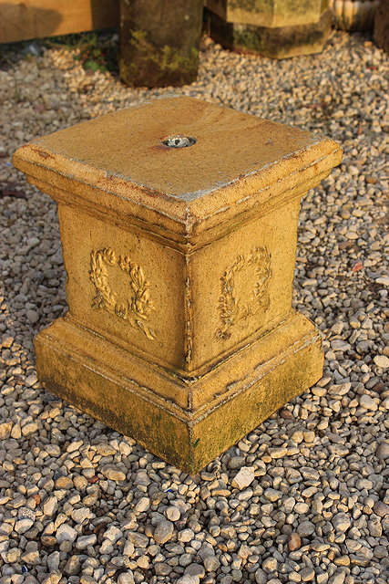 Appraisal: A MUSTARD GLAZED TERROCOTTA SQUARE PLINTH WITH LAUREL WREATH DECORATION