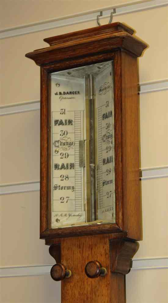 Appraisal: A Victorian oak stick barometer with ivory scale and thermometer