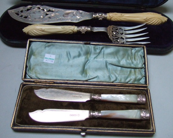 Appraisal: A pair of plated fish servers with engraved and pierced