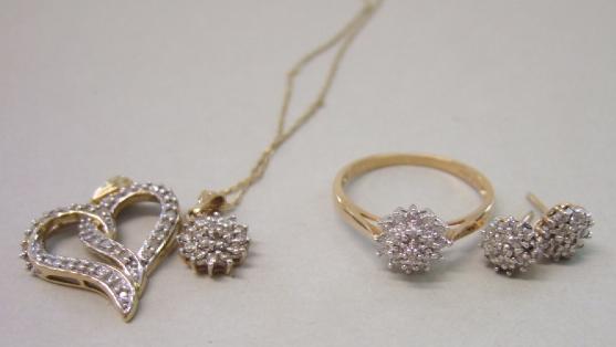 Appraisal: A gold and diamond set circular cluster pendant with a