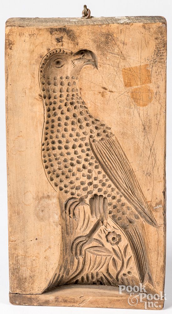 Appraisal: Carved parrot cookie board th c Carved parrot cookie board