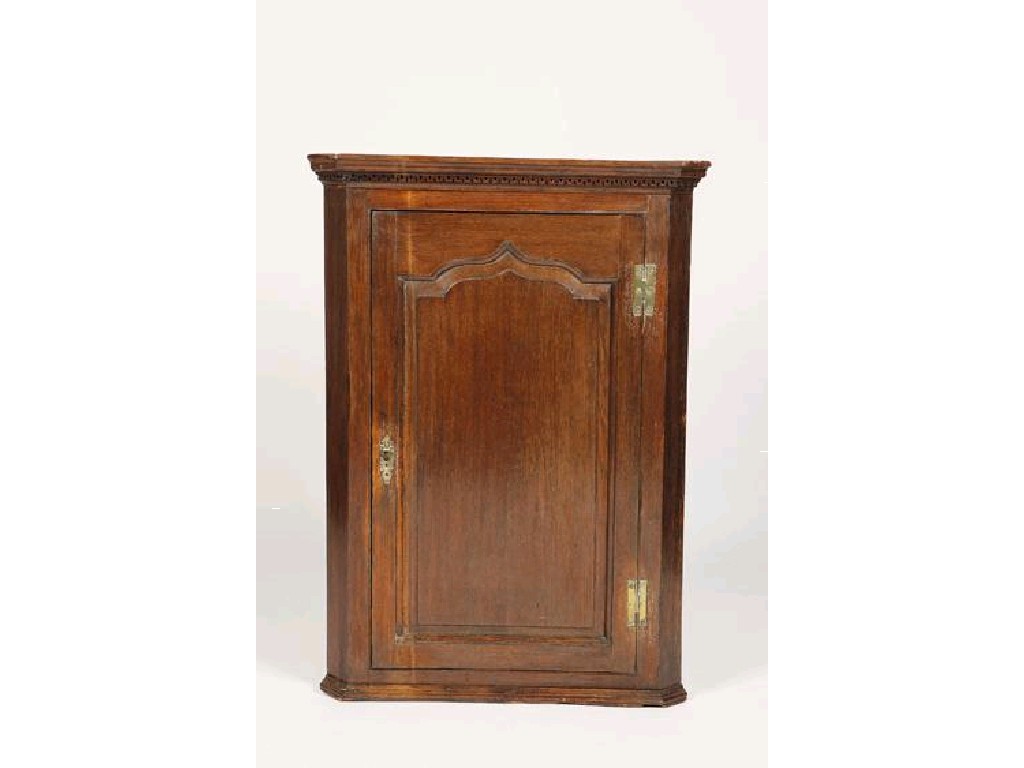 Appraisal: A GEORGE III OAK HANGING CORNER CUPBOARD the moulded cornice