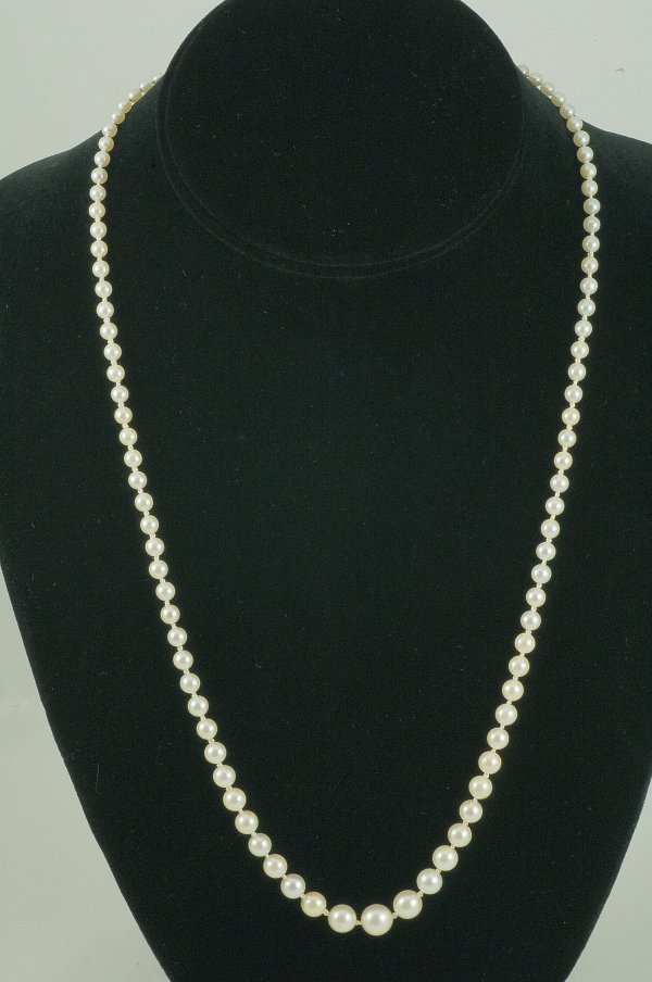 Appraisal: DESCRIPTON Graduated pearl necklace long Knotted strand of Akoya salt