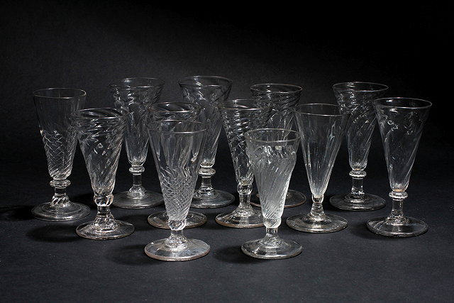 Appraisal: A GROUP OF TWELVE DWARF ALE GLASSES with wrythen decoration