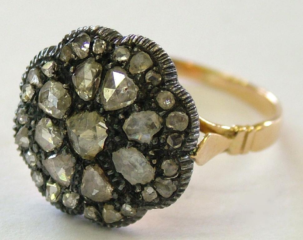 Appraisal: Antique diamond flower cluster ring set with three rows of