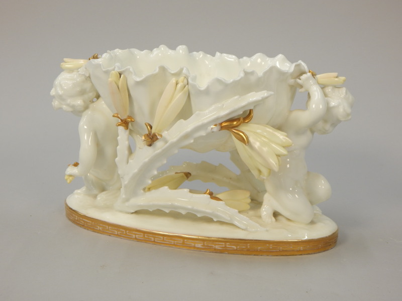 Appraisal: A Victorian Moore Bros porcelain centrepiece modelled in the form