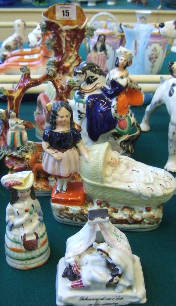 Appraisal: A group of Staffordshire figures th century including a spill