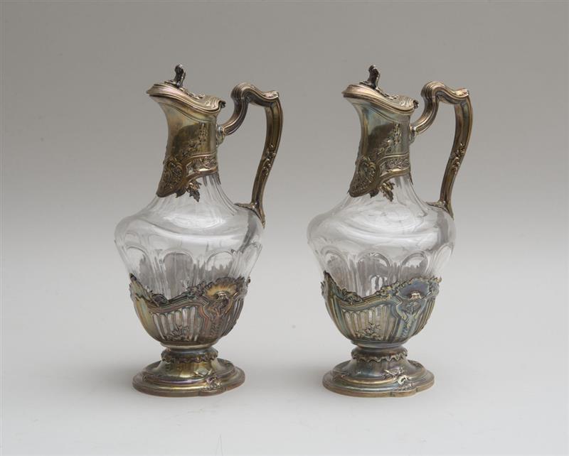 Appraisal: PAIR OF CONTINENTAL CUT-GLASS CLARET JUGS WITH SILVER-PLATED MOUNTS in