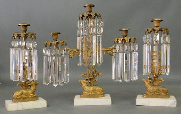 Appraisal: Three-piece gilt metal girandole set with drop prisms seated stag