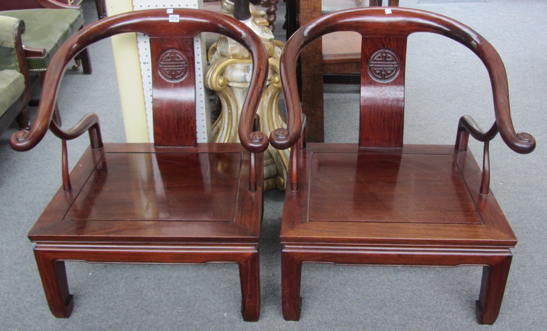 Appraisal: A pair of th century Chinese hardwood horse-shoe back low