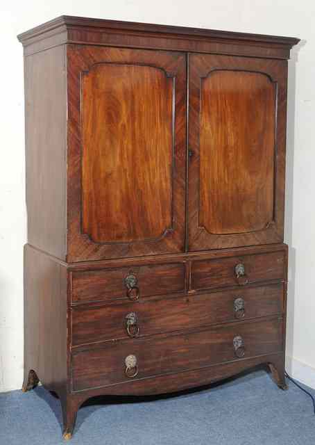 Appraisal: A GEORGE III MAHOGANY LINEN PRESS the two panelled doors