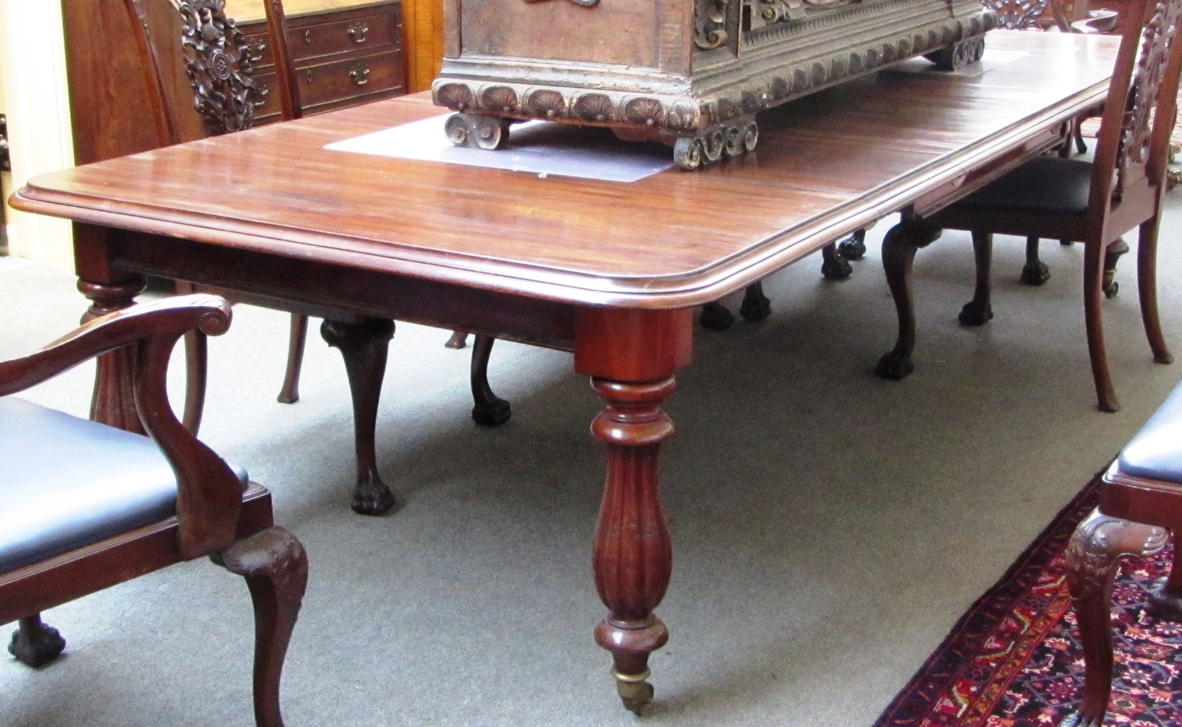 Appraisal: A th century mahogany extending dining table on reverse reeded