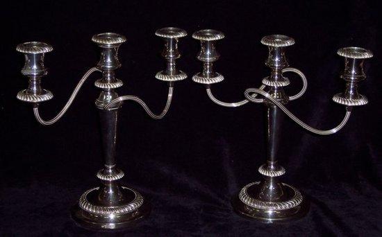 Appraisal: A pair of two-branch three-light candelabra with gadroon borders on