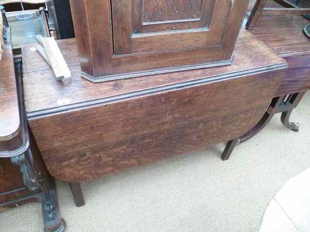 Appraisal: AN ANTIQUE OAK DROP LEAF DINING TABLE standing on square