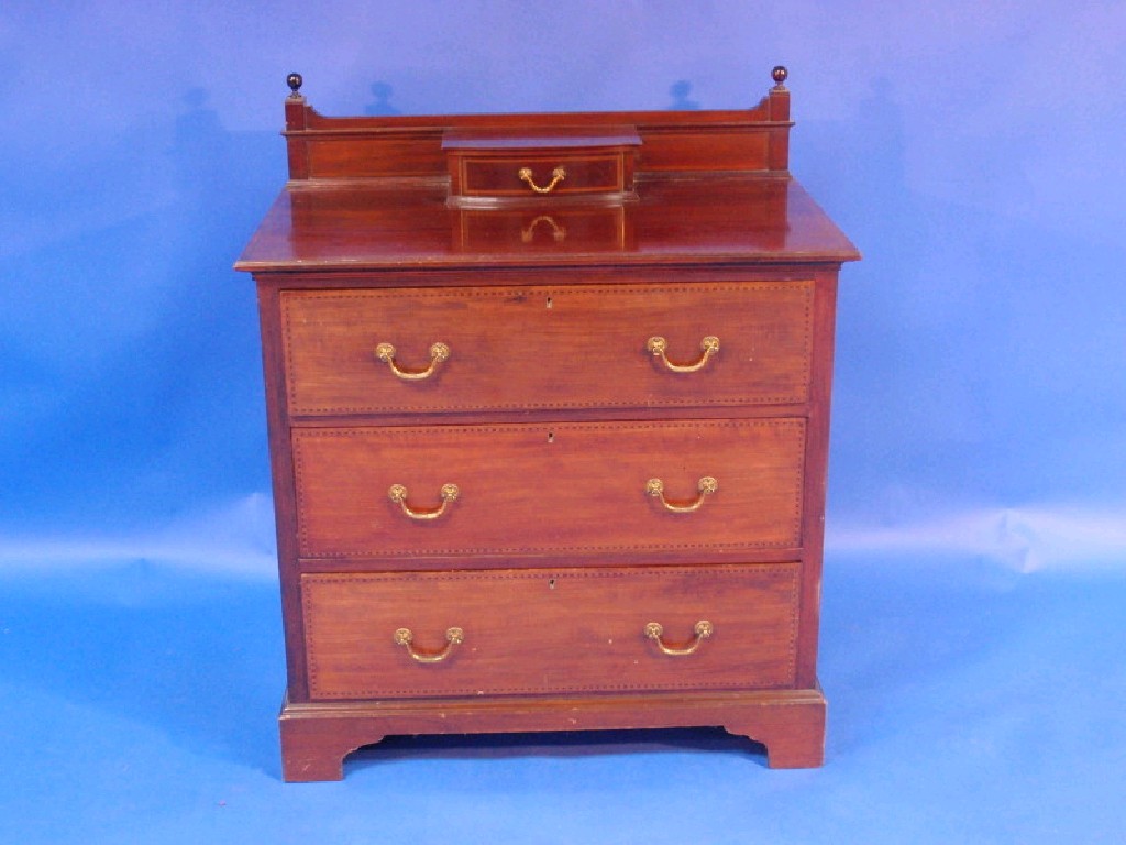 Appraisal: An Edwardian chevron banded mahogany dressing chest with bracket feet