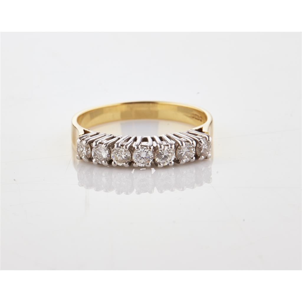 Appraisal: A seven stone diamond ring claw set with a single