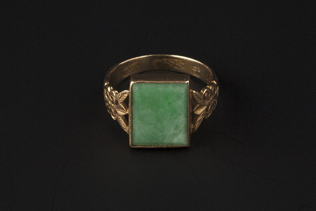 Appraisal: A JADE PANEL RING the rectangular jade panel collet set