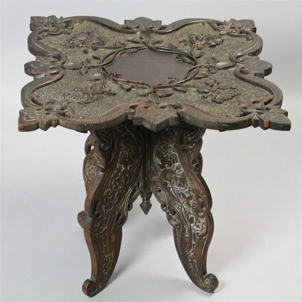 Appraisal: ANGLO-INDIAN CARVED AND INCISED FOLDING ACCENT TABLE the decorative carved